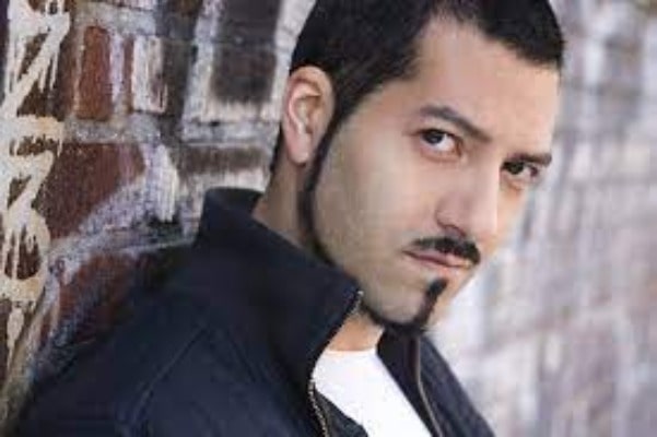 Alfredo Narciso wearing black jacket and white vest  in inside.